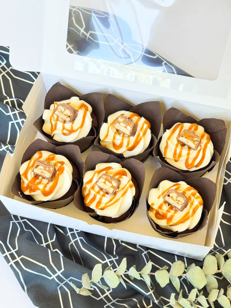 Chocolate cupcakes with caramel and peanut in the box Active Image