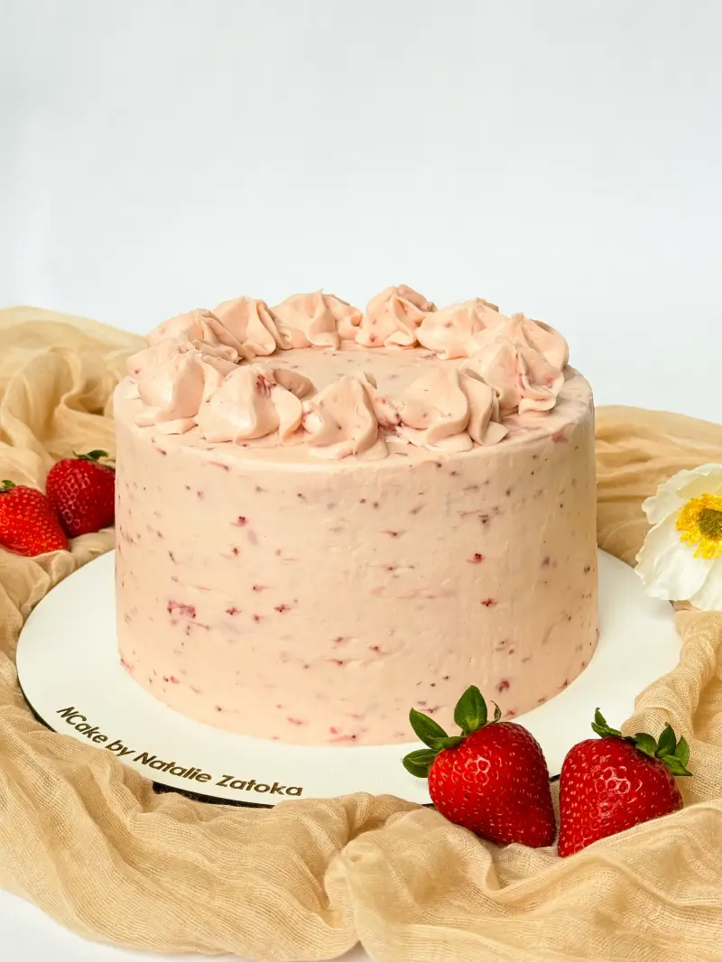 whole vanilla strawberry cake on the cake board Active Image