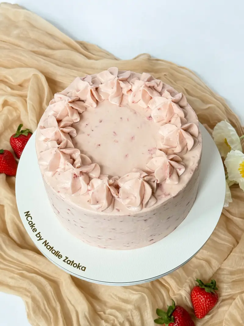 whole vanilla strawberry cake on the cake board Active Image