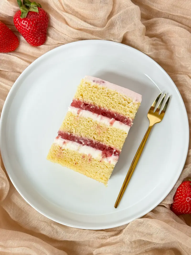 slice of vanilla strawberry cake on the cake plate Active Image