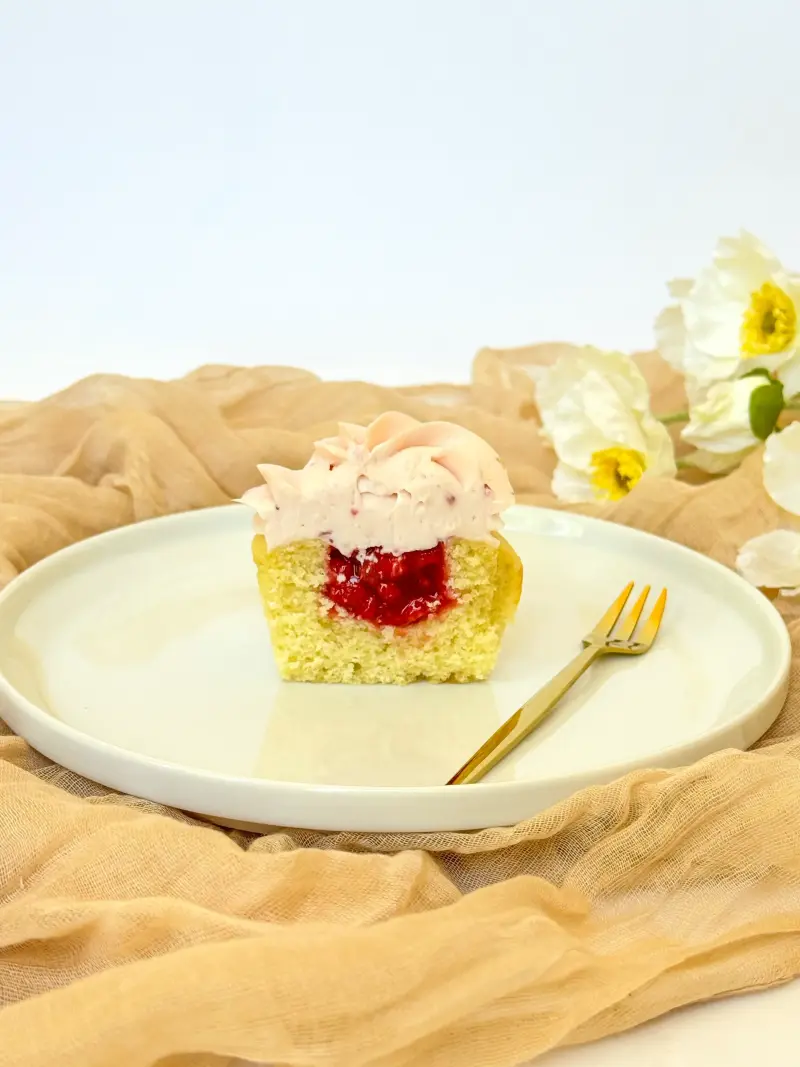 cut inside of vanilla strawberry cupcake Active Image