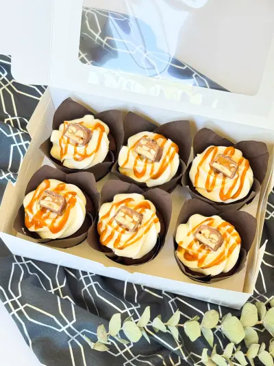 Chocolate cupcakes with caramel and peanut in the box