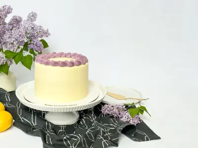 Poppy-Lemon Cake with lilac flowers on the cake stand